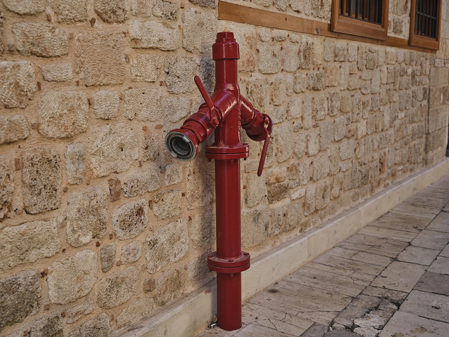 Fire pump installed by a stone wall