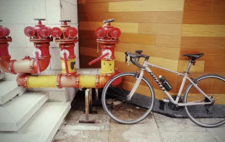 Bicycle parked by fire pump