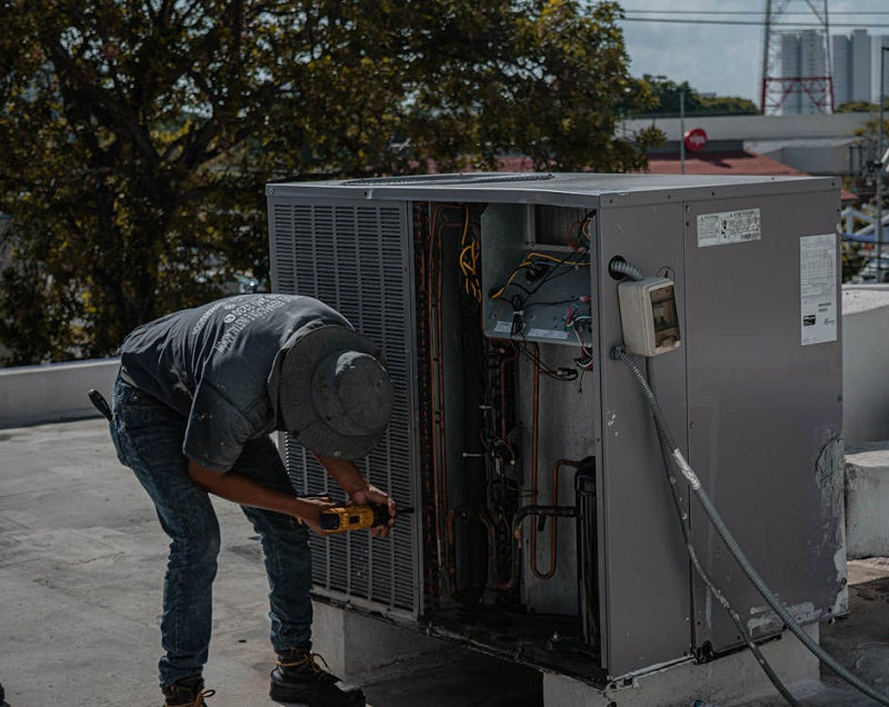 Technician repairing HVAC equipment