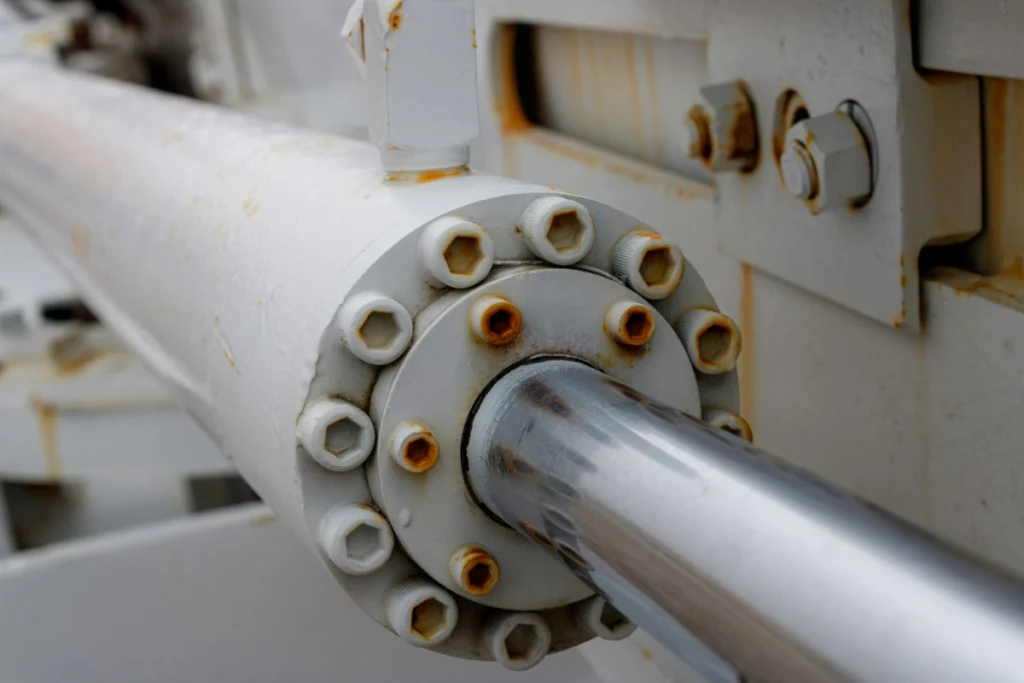 A faded silver piston inside a hydraulic machine in a plant